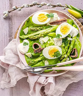 Salad with eggs, asparagus, anchovies and cheese sauce