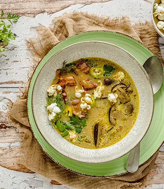 Mushroom soup with crispy bacon and popcorn