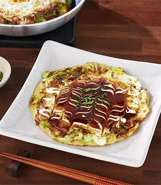 Okonomiyaki ''Japanese Savoury Pancake'' with meat buta-tama