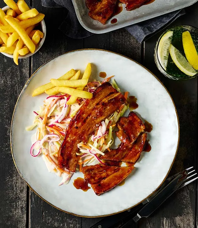 Pork belly BBQ teriyaki sauce with coleslaw and fries