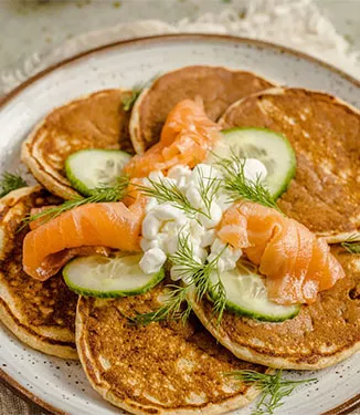 Wholegrain pancakes with smoked salmon, cottage cheese and cucumber