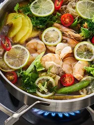 Vietnamese lẩu cá chua—hot pot with fish