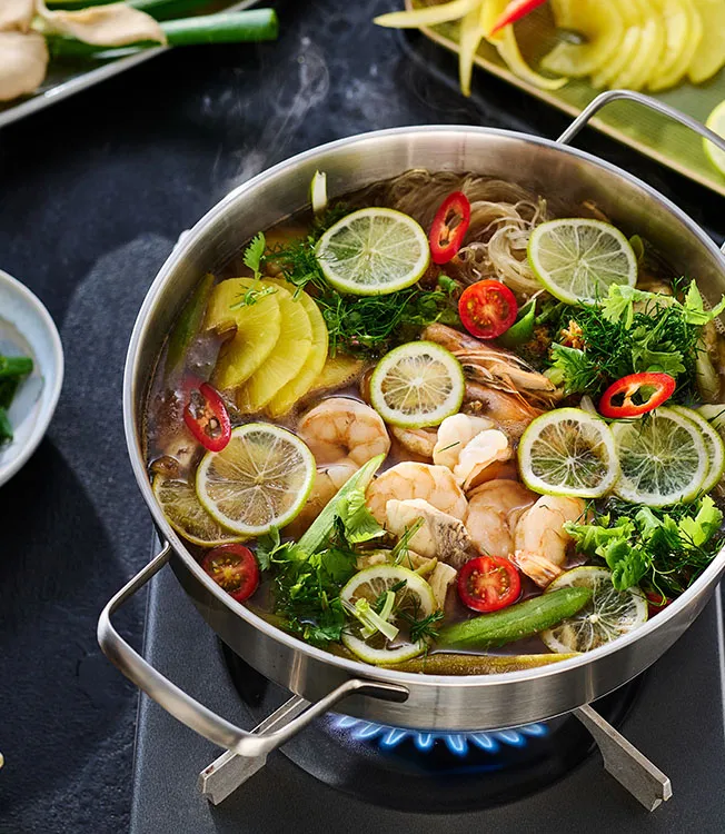 Vietnamese lẩu cá chua—hot pot with fish