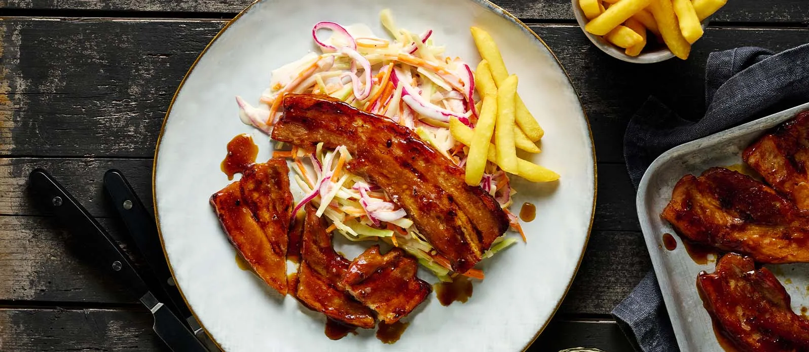 Pork belly BBQ teriyaki sauce with coleslaw and fries