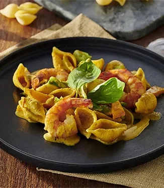Conchiglie prawns and vegetables with curry cream sauce