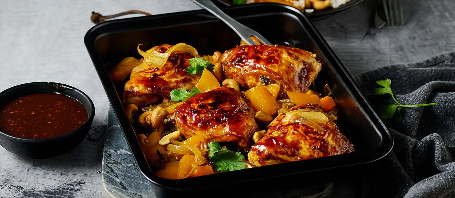 Marinated chicken thighs baked with cashews and peppers